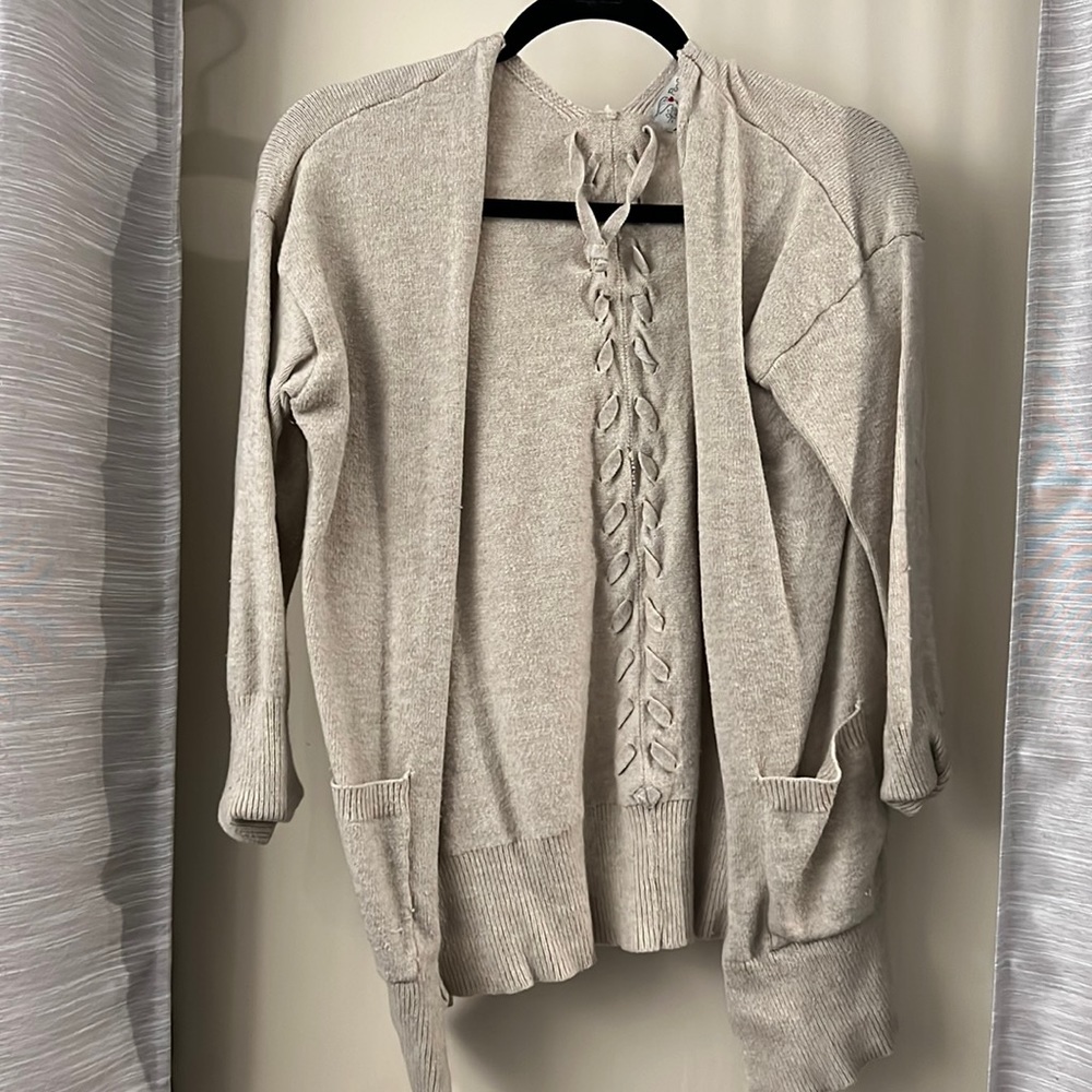Beige sweater with braid in back. Size large
